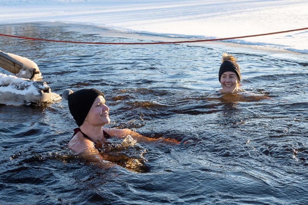 Two women swimming in icy lake